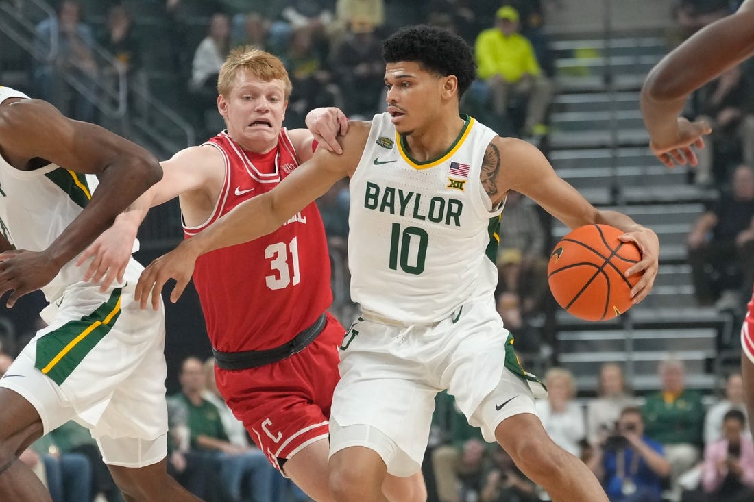 Jan 2, 2024; Waco, Texas, USA;  Baylor Bears guard RayJ Dennis (10) controls the ball against Cornell Big Red guard Cooper Noard (31) during the first half at Paul and Alejandra Foster Pavilion. Mandatory Credit: Chris Jones-USA TODAY Sports