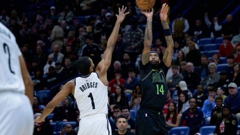 Jan 2, 2024; New Orleans, Louisiana, USA;  New Orleans Pelicans forward Brandon Ingram (14) shoots a three point basket against Brooklyn Nets forward Mikal Bridges (1) at Smoothie King Center. Mandatory Credit: Matthew Hinton-USA TODAY Sports