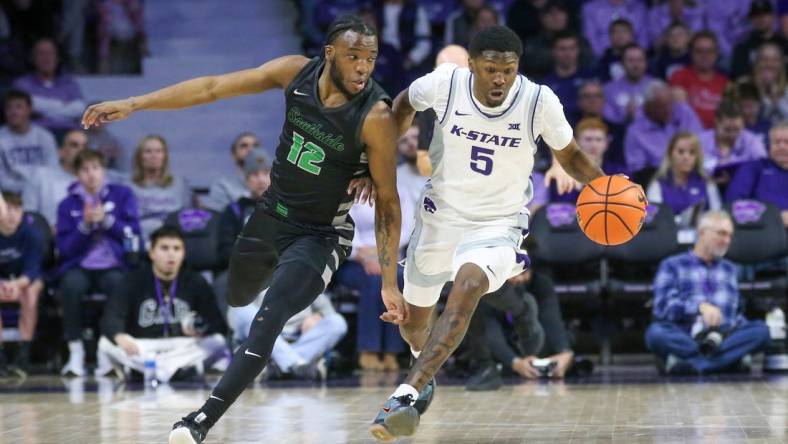 Jan 2, 2024; Manhattan, Kansas, USA; Kansas State Wildcats guard Cam Carter (5) brings the ball up court against Chicago State Cougars guard Brent Davis (12) during the first half at Bramlage Coliseum. Mandatory Credit: Scott Sewell-USA TODAY Sports