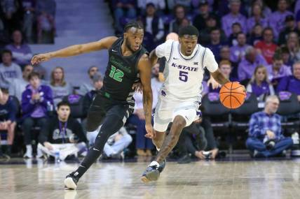 Jan 2, 2024; Manhattan, Kansas, USA; Kansas State Wildcats guard Cam Carter (5) brings the ball up court against Chicago State Cougars guard Brent Davis (12) during the first half at Bramlage Coliseum. Mandatory Credit: Scott Sewell-USA TODAY Sports