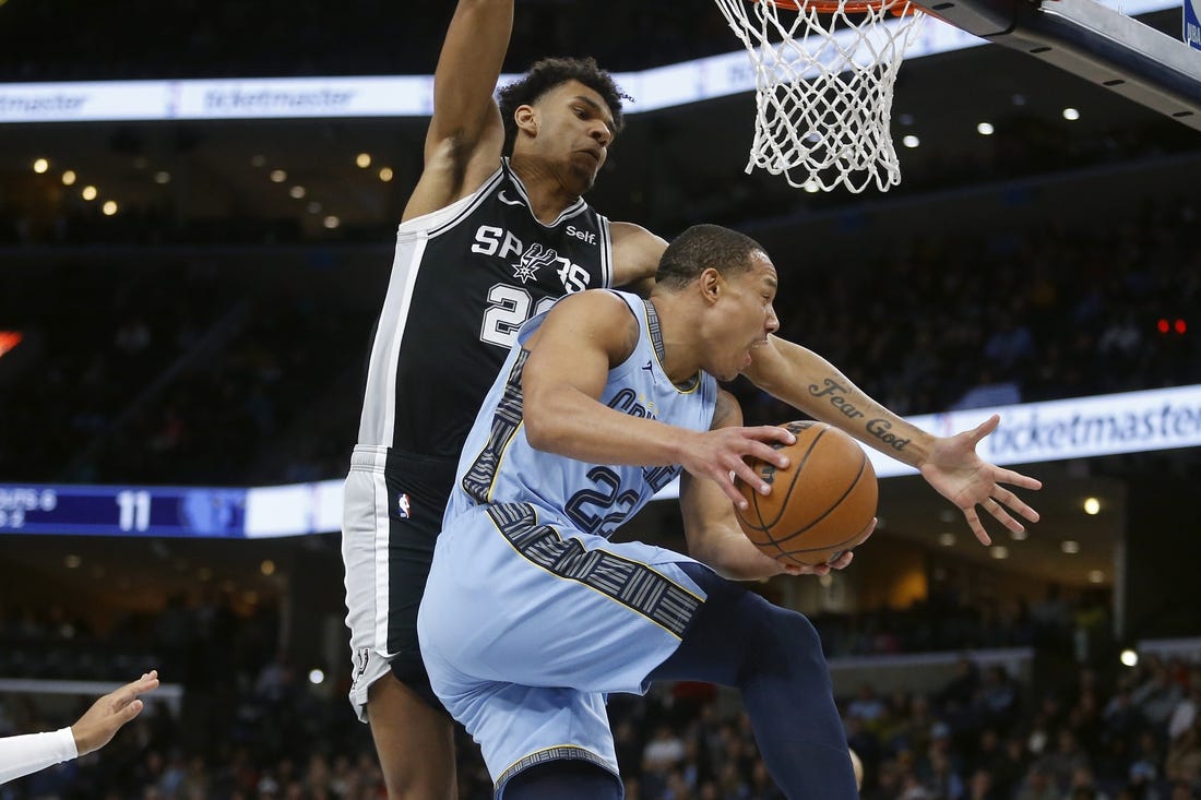 Jan 2, 2024; Memphis, Tennessee, USA; Memphis Grizzlies guard Desmond Bane (22) passes the ball as San Antonio Spurs forward Dominick Barlow (26) defends during the first half at FedExForum. Mandatory Credit: Petre Thomas-USA TODAY Sports