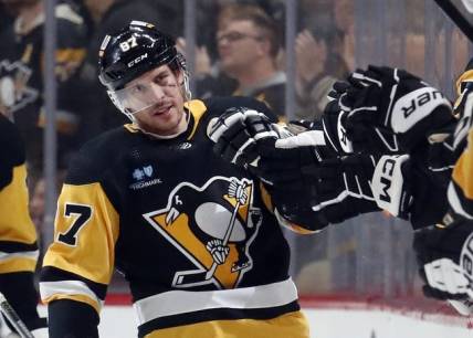 Jan 2, 2024; Pittsburgh, Pennsylvania, USA;  Pittsburgh Penguins center Sidney Crosby (87) celebrates with the Pens bench after scoring a power play goal against the Washington Capitals during the second period at PPG Paints Arena. Mandatory Credit: Charles LeClaire-USA TODAY Sports