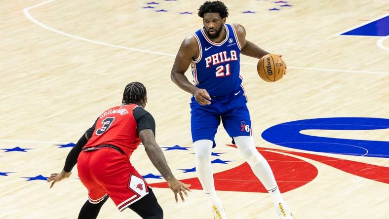 Jan 2, 2024; Philadelphia, Pennsylvania, USA; Philadelphia 76ers center Joel Embiid (21) controls the ball against Chicago Bulls center Andre Drummond (3) during the third quarter at Wells Fargo Center. Mandatory Credit: Bill Streicher-USA TODAY Sports