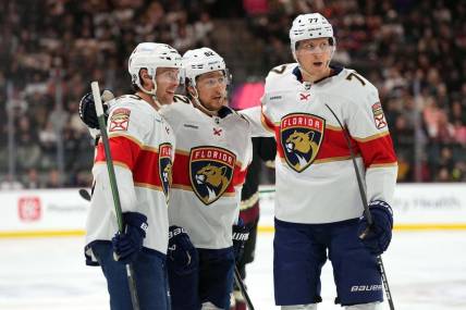 Jan 2, 2024; Tempe, Arizona, USA; Florida Panthers center Carter Verhaeghe (23) celebrates his goal with Florida Panthers defenseman Brandon Montour (62) and Florida Panthers defenseman Niko Mikkola (77) against the Arizona Coyotes during the first period at Mullett Arena. Mandatory Credit: Joe Camporeale-USA TODAY Sports