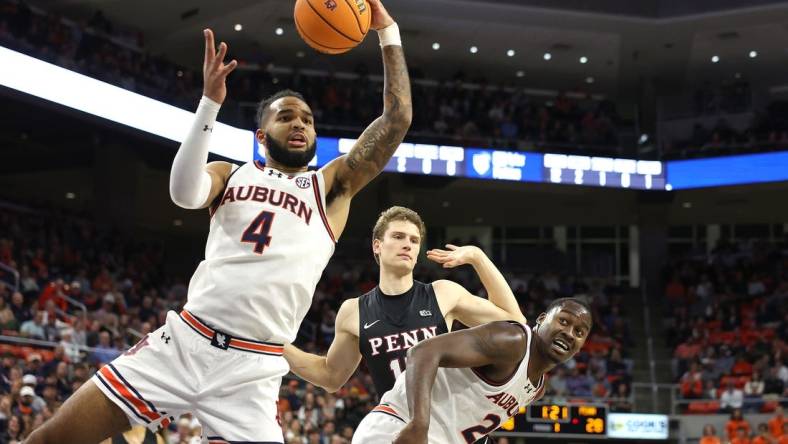 Jan 2, 2024; Auburn, Alabama, USA;  Auburn Tigers forward Johni Broome (4) controls a rebound during the first half against the Pennsylvania Quakers at Neville Arena. Mandatory Credit: John Reed-USA TODAY Sports