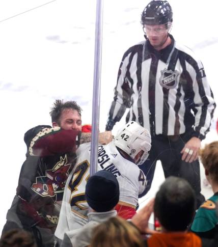 Jan 2, 2024; Tempe, Arizona, USA; Arizona Coyotes left wing Jason Zucker (16) fights Florida Panthers defenseman Gustav Forsling (42) during the second period at Mullett Arena. Mandatory Credit: Joe Camporeale-USA TODAY Sports