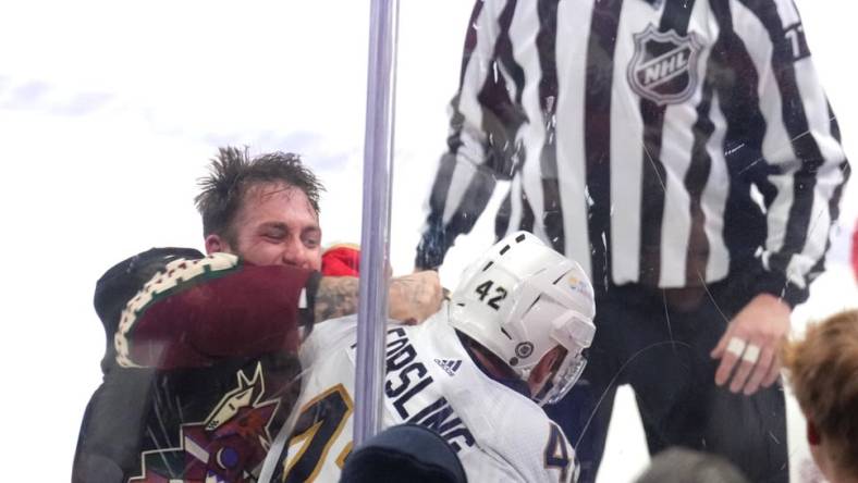 Jan 2, 2024; Tempe, Arizona, USA; Arizona Coyotes left wing Jason Zucker (16) fights Florida Panthers defenseman Gustav Forsling (42) during the second period at Mullett Arena. Mandatory Credit: Joe Camporeale-USA TODAY Sports