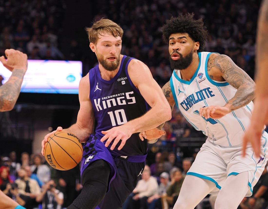 Jan 2, 2024; Sacramento, California, USA; Sacramento Kings center Domantas Sabonis (10) controls the ball against Charlotte Hornets center Nick Richards (4) during the second quarter at Golden 1 Center. Mandatory Credit: Kelley L Cox-USA TODAY Sports