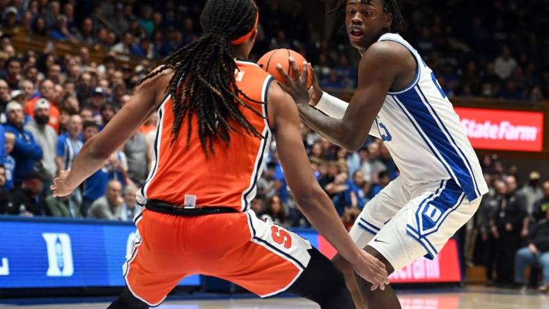 Jan 2, 2024; Durham, North Carolina, USA;  Duke Blue Devils forward Mark Mitchell (25) controls the ball in front of Syracuse Orange forward Maliq Brown (1) during the second half at Cameron Indoor Stadium.  The Blue Devils won 86-66. Mandatory Credit: Rob Kinnan-USA TODAY Sports