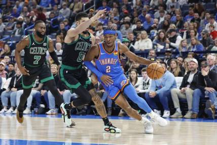 Jan 2, 2024; Oklahoma City, Oklahoma, USA; Oklahoma City Thunder guard Shai Gilgeous-Alexander (2) drives to the basket against Boston Celtics forward Jayson Tatum (0) during the second quarter at Paycom Center. Mandatory Credit: Alonzo Adams-USA TODAY Sports