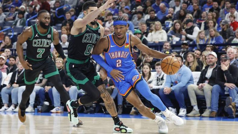 Jan 2, 2024; Oklahoma City, Oklahoma, USA; Oklahoma City Thunder guard Shai Gilgeous-Alexander (2) drives to the basket against Boston Celtics forward Jayson Tatum (0) during the second quarter at Paycom Center. Mandatory Credit: Alonzo Adams-USA TODAY Sports