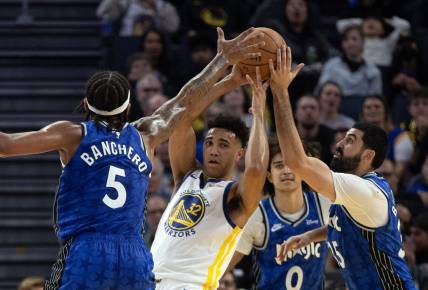 Jan 2, 2024; San Francisco, California, USA; Golden State Warriors forward Trayce Jackson-Davis (32) looks to pass away from defensive pressure from Orlando Magic players during the second quarter at Chase Center. Mandatory Credit: D. Ross Cameron-USA TODAY Sports