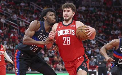 Jan 1, 2024; Houston, Texas, USA; Houston Rockets center Alperen Sengun (28) controls the ball as Detroit Pistons center James Wiseman (13) defends during the game at Toyota Center. Mandatory Credit: Troy Taormina-USA TODAY Sports