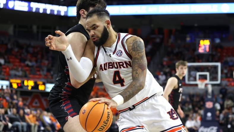 Jan 2, 2024; Auburn, Alabama, USA;  Auburn Tigers forward Johni Broome (4) is the focus of Arkansas' defense this weekend. Mandatory Credit: John Reed-USA TODAY Sports