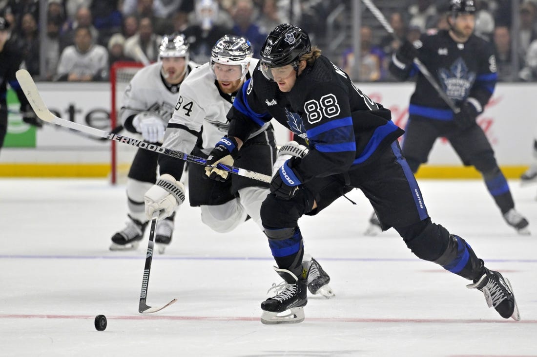 Jan 2, 2024; Los Angeles, California, USA; Toronto Maple Leafs right wing William Nylander (88) skates the puck past Los Angeles Kings defenseman Vladislav Gavrikov (84) in the first period at Crypto.com Arena. Mandatory Credit: Jayne Kamin-Oncea-USA TODAY Sports