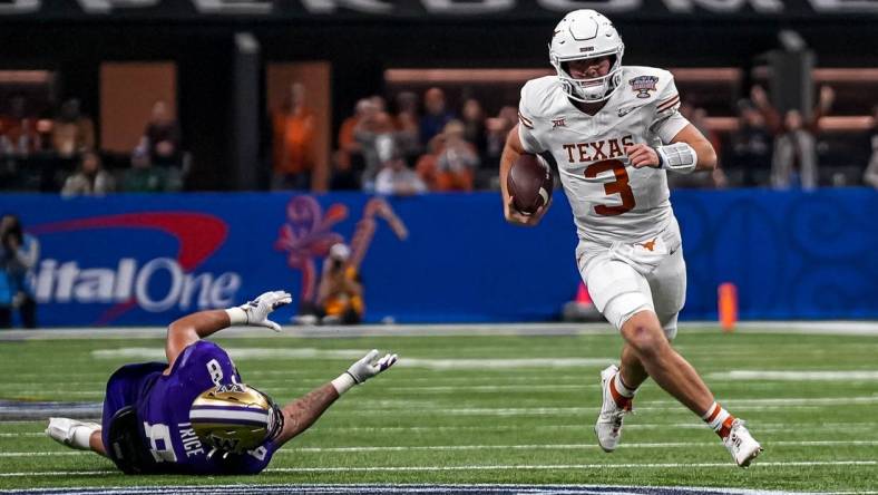 Texas Longhorns quarterback Quinn Ewers (3) evades a tackle by Washington edge Bralen Trice (8) during the Sugar Bowl College Football Playoff  semifinals game at the Caesars Superdome on Monday, Jan. 1, 2024 in New Orleans, Louisiana.