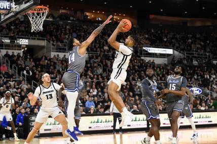 Jan 3, 2024; Providence, Rhode Island, USA; Providence Friars forward Bryce Hopkins (23) shoots the ball over Seton Hall Pirates guard Dre Davis (14) during the first half at Amica Mutual Pavilion. Mandatory Credit: Eric Canha-USA TODAY Sports