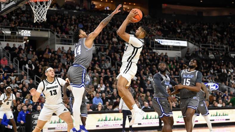 Jan 3, 2024; Providence, Rhode Island, USA; Providence Friars forward Bryce Hopkins (23) shoots the ball over Seton Hall Pirates guard Dre Davis (14) during the first half at Amica Mutual Pavilion. Mandatory Credit: Eric Canha-USA TODAY Sports