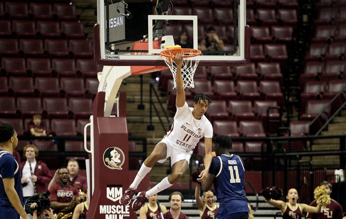 Jan 3, 2024; Tallahassee, Florida, USA; Florida State Seminoles forward Baba Miller (11) hangs on the rim after a dunk during the first half against the Georgia Tech Yellow Jackets at Donald L. Tucker Center. Mandatory Credit: Melina Myers-USA TODAY Sports