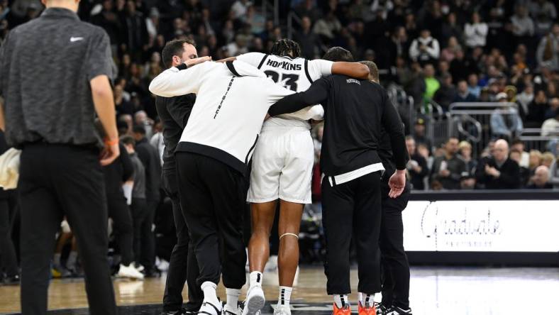 Jan 3, 2024; Providence, Rhode Island, USA; Providence Friars forward Bryce Hopkins (23) is helped by staff after getting injured during the second half against the Seton Hall Pirates at Amica Mutual Pavilion. Mandatory Credit: Eric Canha-USA TODAY Sports