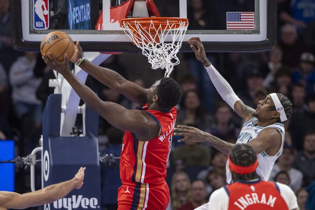 Jan 3, 2024; Minneapolis, Minnesota, USA; New Orleans Pelicans forward Zion Williamson (1) drives to the basket and shoots the ball past Minnesota Timberwolves guard Nickeil Alexander-Walker (9) in the first half at Target Center. Mandatory Credit: Jesse Johnson-USA TODAY Sports