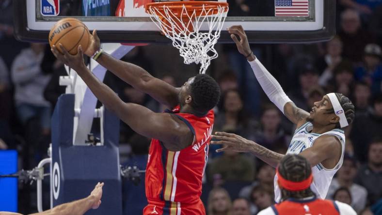 Jan 3, 2024; Minneapolis, Minnesota, USA; New Orleans Pelicans forward Zion Williamson (1) drives to the basket and shoots the ball past Minnesota Timberwolves guard Nickeil Alexander-Walker (9) in the first half at Target Center. Mandatory Credit: Jesse Johnson-USA TODAY Sports