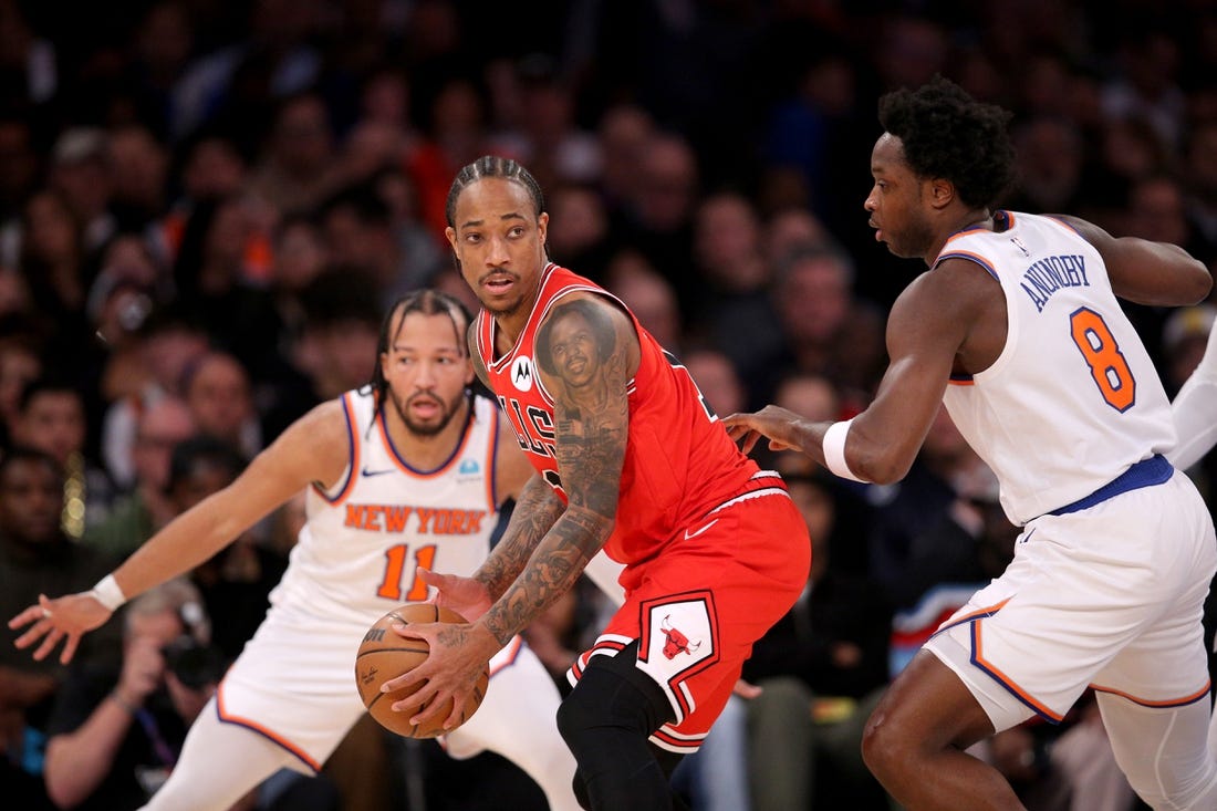 Jan 3, 2024; New York, New York, USA; Chicago Bulls forward DeMar DeRozan (11) controls the ball against New York Knicks guard Jalen Brunson (11) and forward OG Anunoby (8) during the second quarter at Madison Square Garden. Mandatory Credit: Brad Penner-USA TODAY Sports