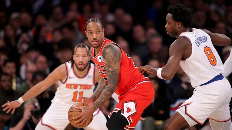 Jan 3, 2024; New York, New York, USA; Chicago Bulls forward DeMar DeRozan (11) controls the ball against New York Knicks guard Jalen Brunson (11) and forward OG Anunoby (8) during the second quarter at Madison Square Garden. Mandatory Credit: Brad Penner-USA TODAY Sports