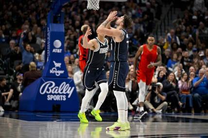 Jan 3, 2024; Dallas, Texas, USA; Dallas Mavericks guard Luka Doncic (77) celebrates after making a three point basket against the Portland Trail Blazers during the second quarter at the American Airlines Center. Mandatory Credit: Jerome Miron-USA TODAY Sports