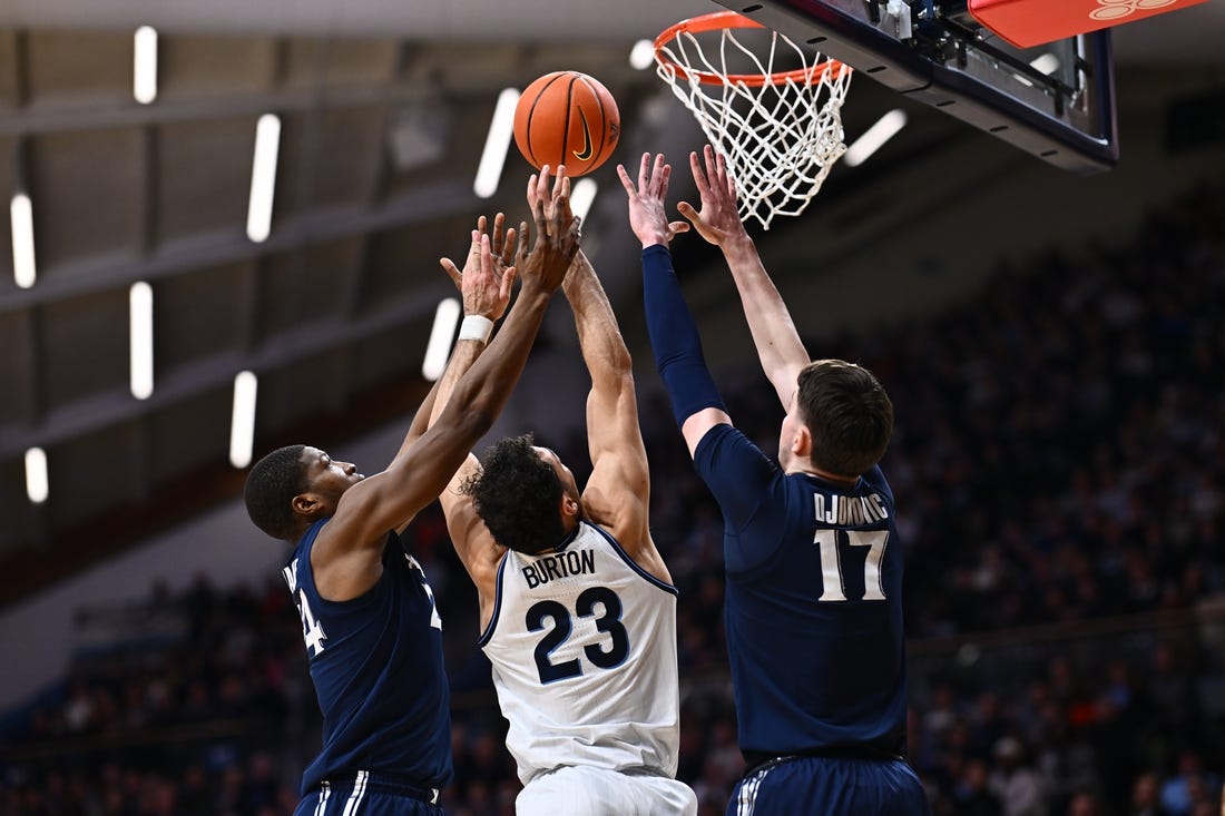 Jan 3, 2024; Villanova, Pennsylvania, USA; Villanova Wildcats forward Tyler Burton (23) reaches for a rebound between Xavier Musketeers forward Abou Ousmane (24) and forward Lazar Djokovic (17) in the first half at William B. Finneran Pavilion. Mandatory Credit: Kyle Ross-USA TODAY Sports