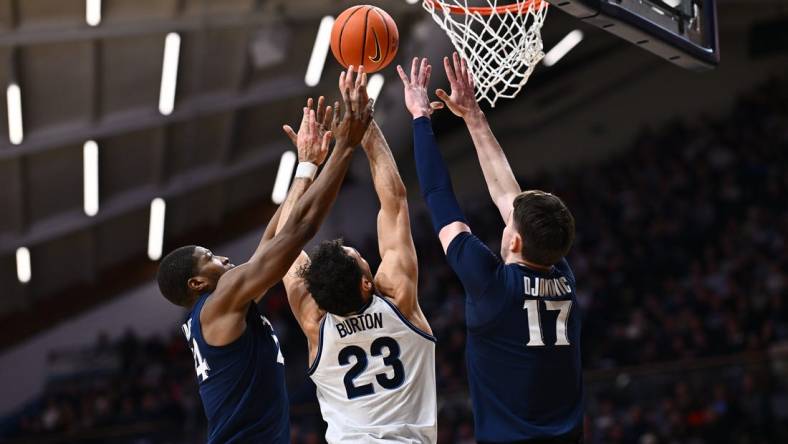 Jan 3, 2024; Villanova, Pennsylvania, USA; Villanova Wildcats forward Tyler Burton (23) reaches for a rebound between Xavier Musketeers forward Abou Ousmane (24) and forward Lazar Djokovic (17) in the first half at William B. Finneran Pavilion. Mandatory Credit: Kyle Ross-USA TODAY Sports