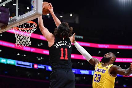 Jan 3, 2024; Los Angeles, California, USA; Miami Heat guard Jaime Jaquez Jr. (11) moves to the basket against Los Angeles Lakers forward LeBron James (23) during the first half at Crypto.com Arena. Mandatory Credit: Gary A. Vasquez-USA TODAY Sports