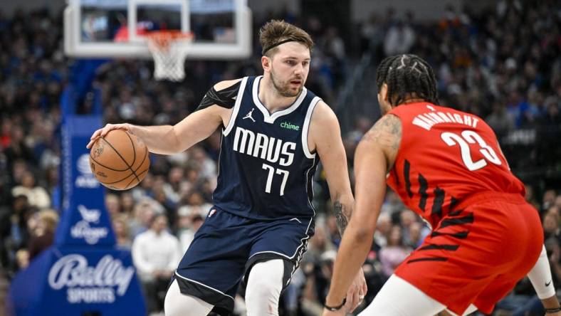 Jan 3, 2024; Dallas, Texas, USA; Dallas Mavericks guard Luka Doncic (77) looks to move the ball past Portland Trail Blazers forward Ish Wainright (23) during the second half at the American Airlines Center. Mandatory Credit: Jerome Miron-USA TODAY Sports