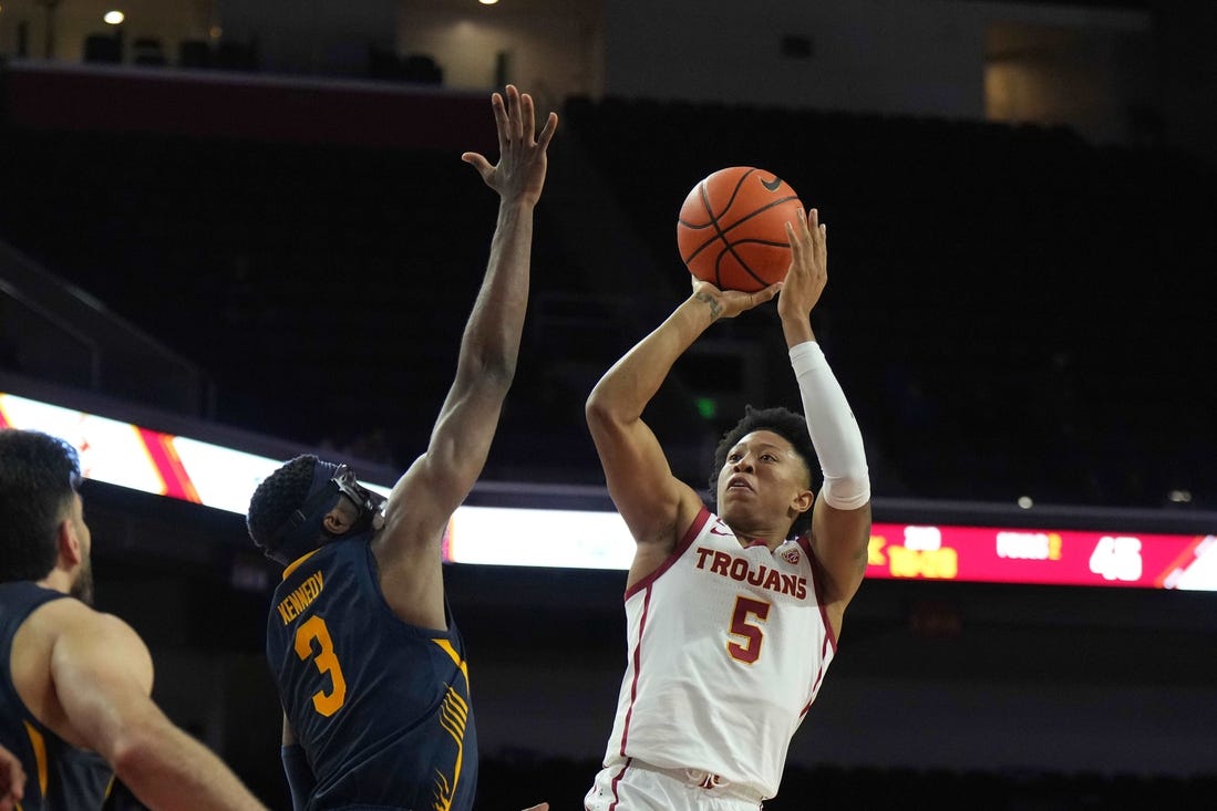 Jan 3, 2024; Los Angeles, California, USA; Southern California Trojans guard Boogie Ellis (5) shoots the ball against California Golden Bears guard Keonte Kennedy (3) in the second half at Galen Center. Mandatory Credit: Kirby Lee-USA TODAY Sports