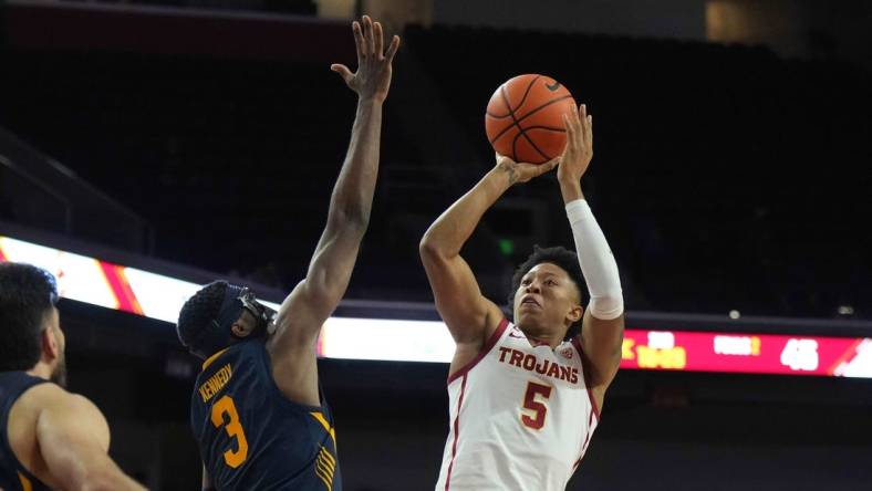 Jan 3, 2024; Los Angeles, California, USA; Southern California Trojans guard Boogie Ellis (5) shoots the ball against California Golden Bears guard Keonte Kennedy (3) in the second half at Galen Center. Mandatory Credit: Kirby Lee-USA TODAY Sports