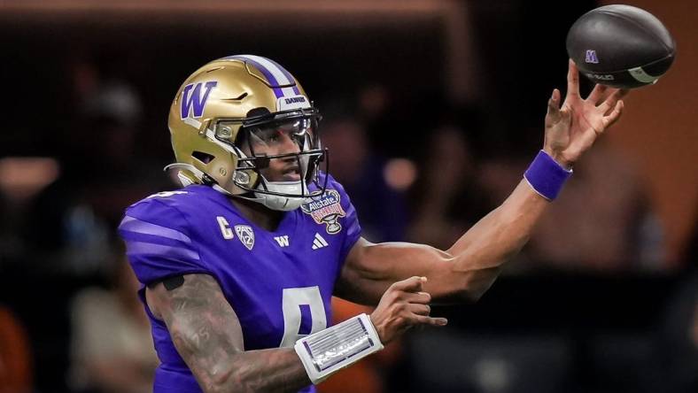 Washington Huskies quarterback Michael Penix Jr. (9) pass the ball during the Sugar Bowl College Football Playoff semi-finals at the Ceasars Superdome in New Orleans, Louisiana, Jan. 1, 2024. The Huskies won the game over the Texas Longhorns 37-31.