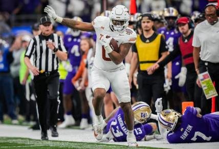 Texas Longhorns tight end Ja'Tavion Sanders (0) evades the Washington Huskies defense during the Sugar Bowl College Football Playoff semi-finals at the Ceasars Superdome in New Orleans, Louisiana, Jan. 1, 2024. The Huskies won the game over the Texas Longhorns 37-31.