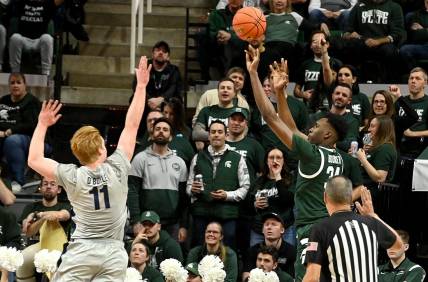 Jan 4, 2024; East Lansing, Michigan, USA; Michigan State Spartans forward Xavier Booker (34) shoots past Penn State Nittany Lions forward Leo O'Boyle (11) during the first half at Jack Breslin Student Events Center. Mandatory Credit: Dale Young-USA TODAY Sports
