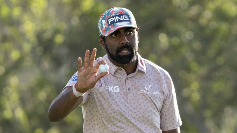 January 4, 2024; Maui, Hawaii, USA; Sahith Theegala acknowledges the crowd after making his putt on the 18th hole during the first round of The Sentry golf tournament at Kapalua Golf - The Plantation Course. Mandatory Credit: Kyle Terada-USA TODAY Sports