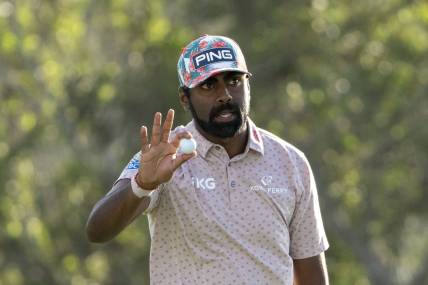 January 4, 2024; Maui, Hawaii, USA; Sahith Theegala acknowledges the crowd after making his putt on the 18th hole during the first round of The Sentry golf tournament at Kapalua Golf - The Plantation Course. Mandatory Credit: Kyle Terada-USA TODAY Sports