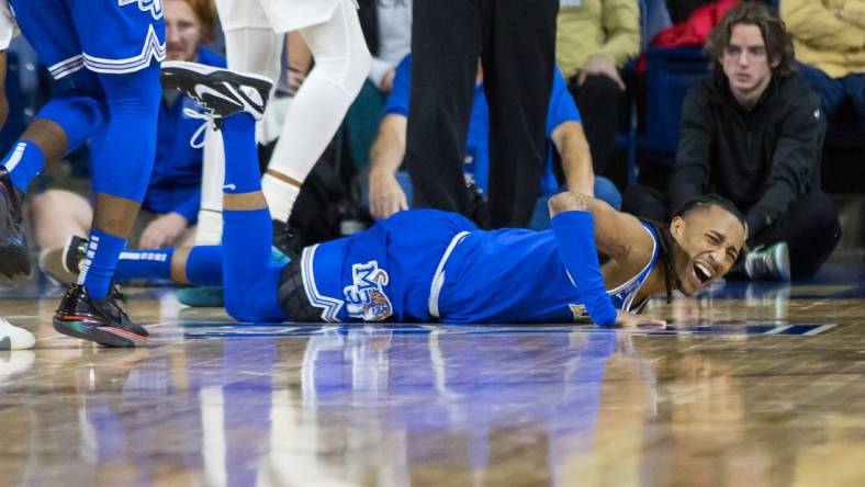 Jan 4, 2024; Tulsa, Oklahoma, USA; Memphis Tigers guard Caleb Mills (9) grimaces in pain after injuring his knee during the first half against the Tulsa Golden Hurricane at the Reynolds Center. The Memphis Tigers won the game 78-75. Mandatory Credit: Brett Rojo-USA TODAY Sports