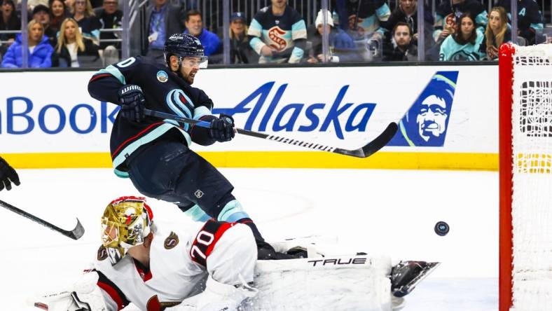 Jan 4, 2024; Seattle, Washington, USA; Seattle Kraken left wing Tomas Tatar (90) scores a goal against Ottawa Senators goaltender Joonas Korpisalo (70) during the second period at Climate Pledge Arena. Mandatory Credit: Joe Nicholson-USA TODAY Sports