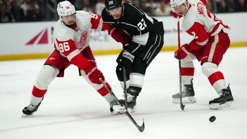 Jan 4, 2024; Los Angeles, California, USA; Detroit Red Wings defenseman Jake Walman (96) and defenseman Olli Maatta (2) battle for the puck with LA Kings left wing Kevin Fiala (22) in the second period at Crypto.com Arena. Mandatory Credit: Kirby Lee-USA TODAY Sports