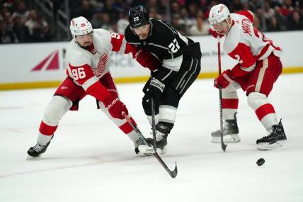 Jan 4, 2024; Los Angeles, California, USA; Detroit Red Wings defenseman Jake Walman (96) and defenseman Olli Maatta (2) battle for the puck with LA Kings left wing Kevin Fiala (22) in the second period at Crypto.com Arena. Mandatory Credit: Kirby Lee-USA TODAY Sports