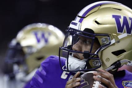 Jan 1, 2024; New Orleans, LA, USA; Washington Huskies quarterback Michael Penix Jr. (9) warms up during a timeout against the Texas Longhorns in the 2024 Sugar Bowl college football playoff semifinal game at Caesars Superdome. Mandatory Credit: Geoff Burke-USA TODAY Sports