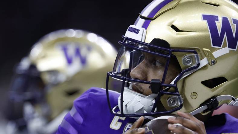 Jan 1, 2024; New Orleans, LA, USA; Washington Huskies quarterback Michael Penix Jr. (9) warms up during a timeout against the Texas Longhorns in the 2024 Sugar Bowl college football playoff semifinal game at Caesars Superdome. Mandatory Credit: Geoff Burke-USA TODAY Sports