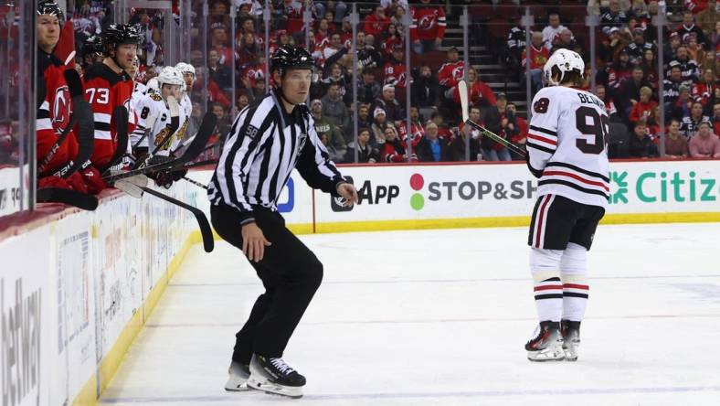 Jan 5, 2024; Newark, New Jersey, USA; Chicago Blackhawks center Connor Bedard (98) leaves the ice after being hit by New Jersey Devils defenseman Brendan Smith (2) (not shown) during the first period at Prudential Center. Mandatory Credit: Ed Mulholland-USA TODAY Sports