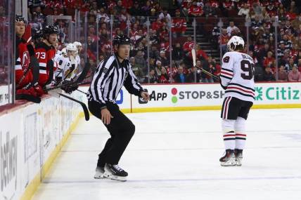 Jan 5, 2024; Newark, New Jersey, USA; Chicago Blackhawks center Connor Bedard (98) leaves the ice after being hit by New Jersey Devils defenseman Brendan Smith (2) (not shown) during the first period at Prudential Center. Mandatory Credit: Ed Mulholland-USA TODAY Sports