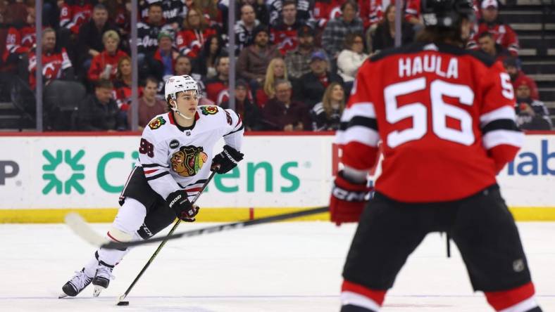 Jan 5, 2024; Newark, New Jersey, USA; Chicago Blackhawks center Connor Bedard (98) skates with the puck against the New Jersey Devils during the first period at Prudential Center. Mandatory Credit: Ed Mulholland-USA TODAY Sports