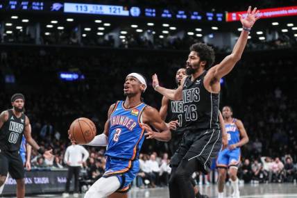 Jan 5, 2024; Brooklyn, New York, USA;  Oklahoma City Thunder guard Shai Gilgeous-Alexander (2) drives past Brooklyn Nets guard Spencer Dinwiddie (26) in the fourth quarter at Barclays Center. Mandatory Credit: Wendell Cruz-USA TODAY Sports